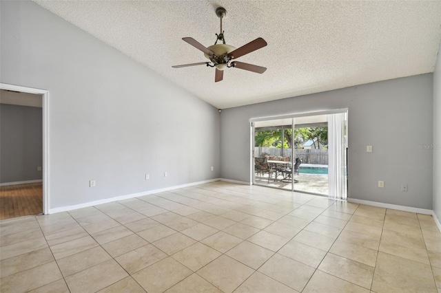 spare room with light tile patterned floors, a textured ceiling, and ceiling fan