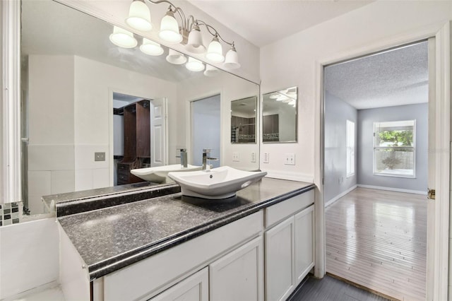 bathroom with vanity and a textured ceiling