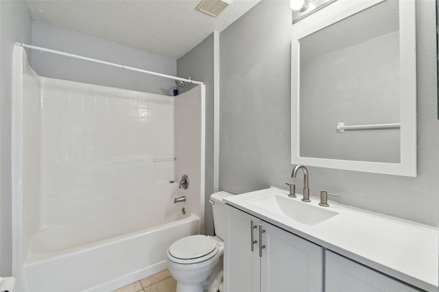 full bathroom featuring tile patterned floors, shower / bathing tub combination, a textured ceiling, toilet, and vanity