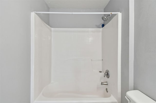 bathroom with toilet and tub / shower combination