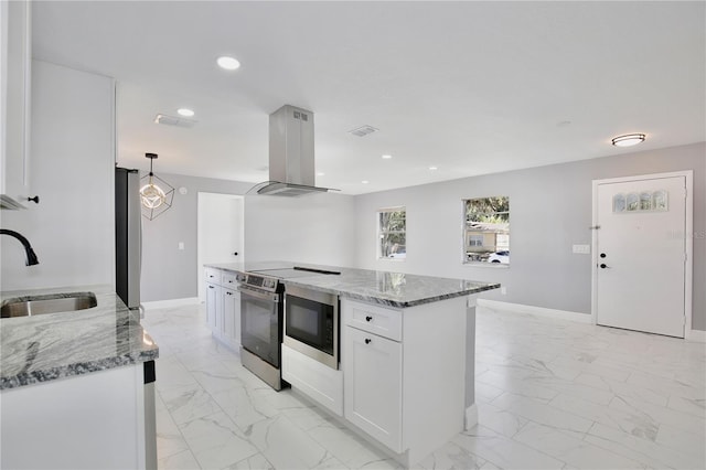 kitchen featuring light stone countertops, island range hood, hanging light fixtures, white cabinetry, and stainless steel appliances