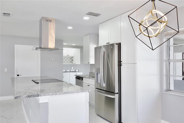 kitchen with white cabinetry, light stone countertops, stainless steel appliances, and wall chimney range hood