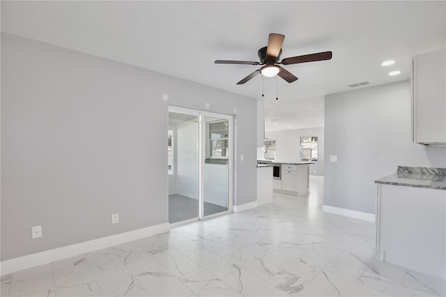 unfurnished living room with ceiling fan