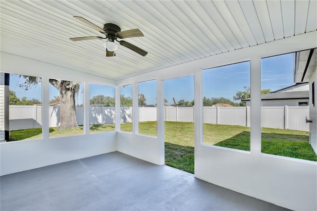 unfurnished sunroom with ceiling fan