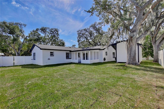 rear view of house featuring a lawn