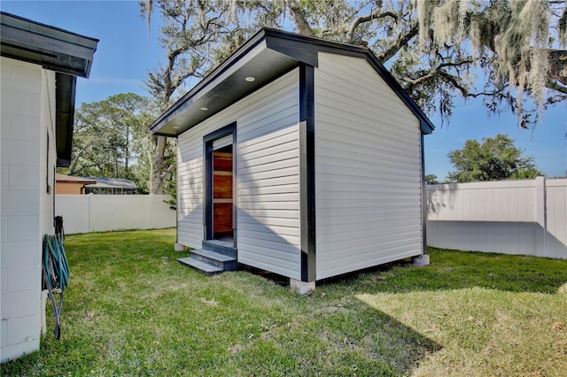 view of outdoor structure featuring a lawn