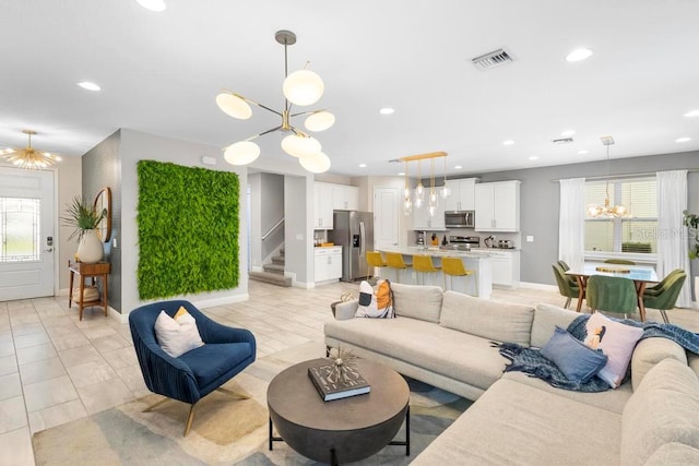 living room featuring a notable chandelier and light tile patterned floors