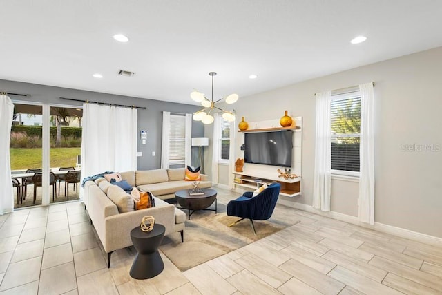 living room featuring a wealth of natural light and a notable chandelier