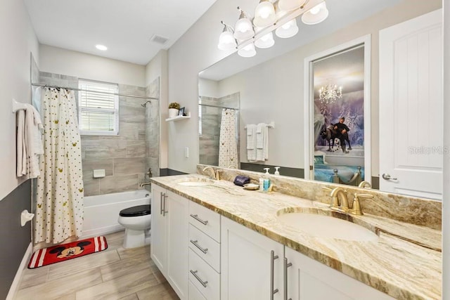 full bathroom featuring vanity, toilet, and shower / tub combo