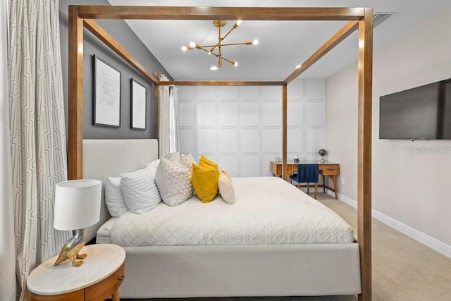 carpeted bedroom featuring a notable chandelier