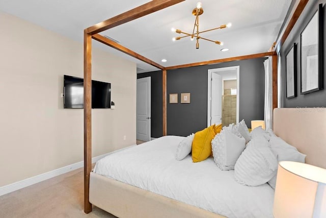 carpeted bedroom featuring connected bathroom and a chandelier