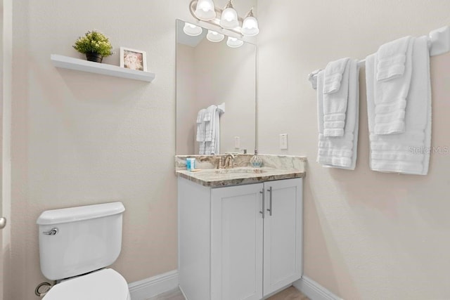 bathroom with toilet and vanity