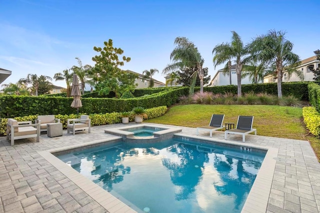 view of swimming pool featuring an in ground hot tub, a patio, and a lawn