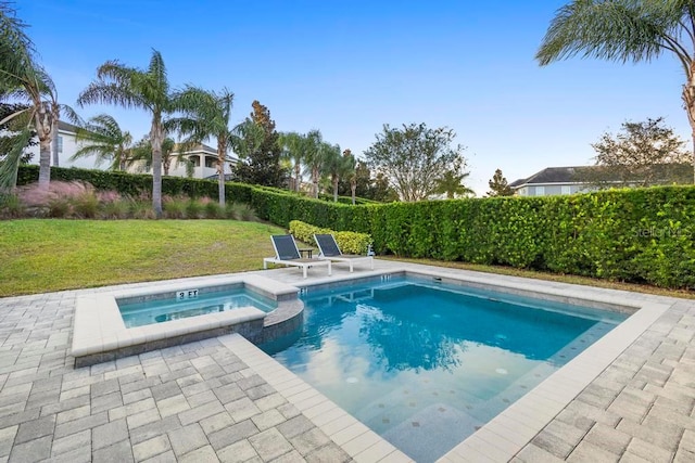 view of pool featuring an in ground hot tub, a yard, and a patio