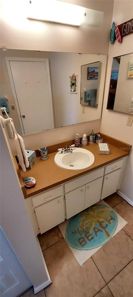 bathroom with tile patterned flooring and vanity