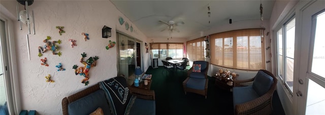 sunroom / solarium with ceiling fan and vaulted ceiling