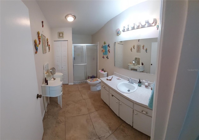 bathroom with tile patterned flooring, vanity, toilet, and walk in shower