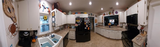 kitchen featuring lofted ceiling, white cabinets, black appliances, sink, and light tile patterned floors