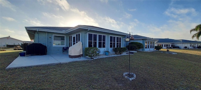 rear view of property with a patio area and a lawn