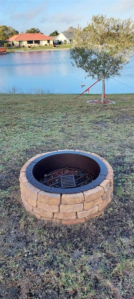 view of yard featuring a water view and a fire pit