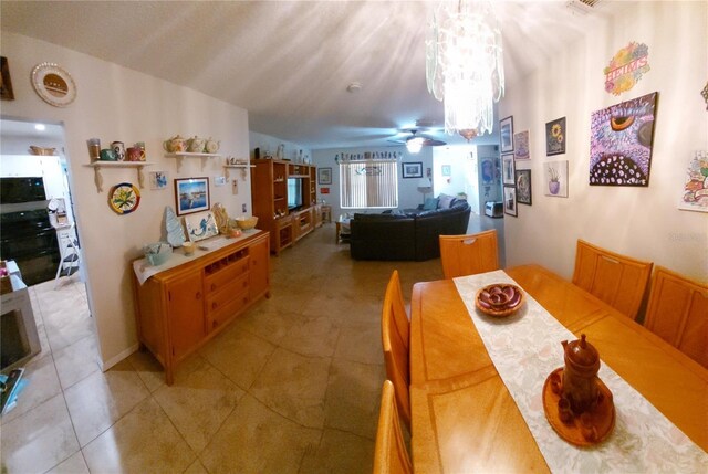 906 Bluewater Dr, Sun City Center, FL 33573 - dining room with light tile patterned flooring, a ceiling fan, and a chandelier