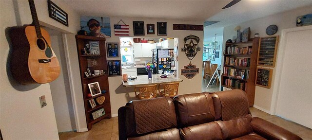 906 Bluewater Dr, Sun City Center, FL 33573 - living room with light tile patterned floors and ceiling fan