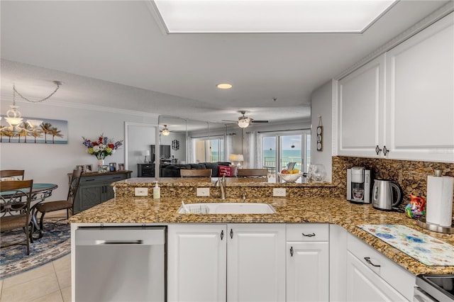 kitchen with kitchen peninsula, sink, stainless steel dishwasher, white cabinets, and ceiling fan with notable chandelier