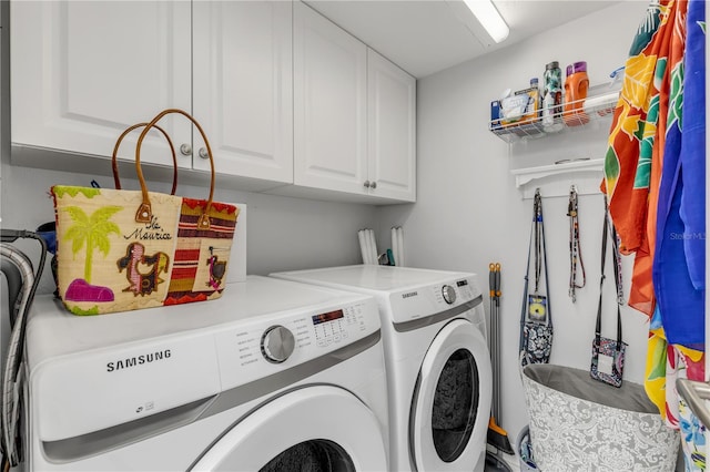 laundry area with cabinets and separate washer and dryer