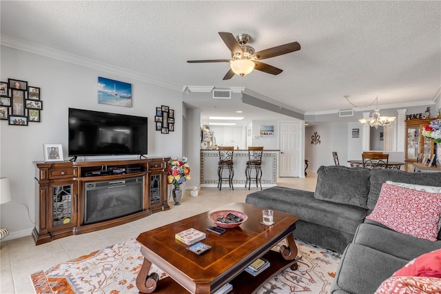 tiled living room with ornamental molding, a textured ceiling, and ceiling fan with notable chandelier