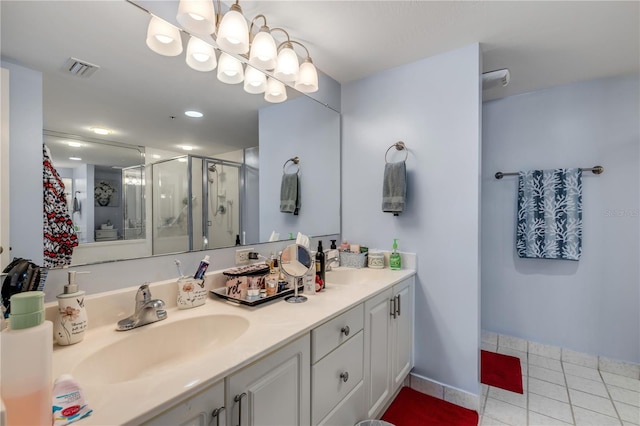 bathroom featuring vanity, tile patterned floors, and a shower with shower door