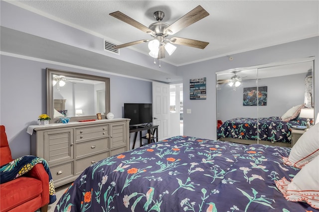 bedroom featuring a closet, ceiling fan, ornamental molding, and a textured ceiling