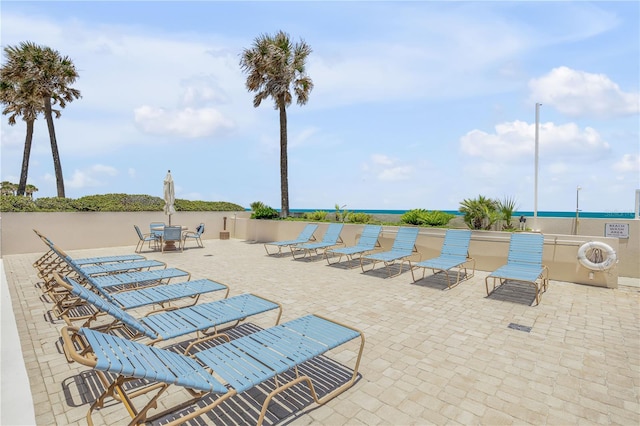 view of pool with a patio and a water view