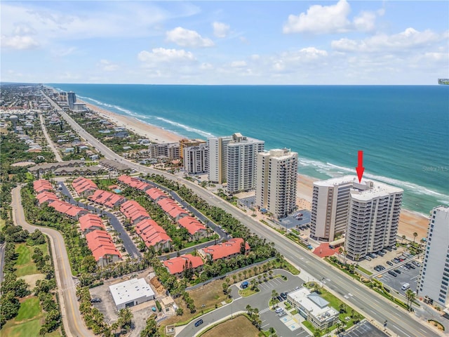 aerial view with a water view and a beach view