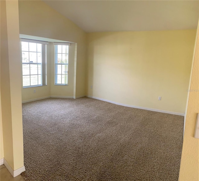 2688 Hawthorne Ln, Kissimmee, FL 34743 - spare room with carpet, lofted ceiling, and baseboards