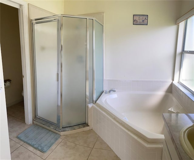 2688 Hawthorne Ln, Kissimmee, FL 34743 - bathroom featuring plenty of natural light, a garden tub, a shower stall, and tile patterned flooring