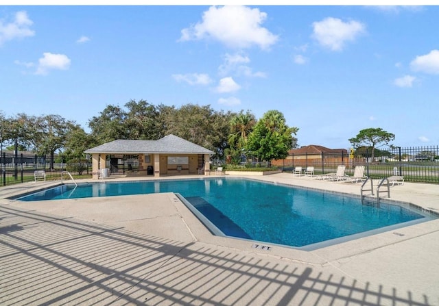 2688 Hawthorne Ln, Kissimmee, FL 34743 - community pool featuring a patio and fence