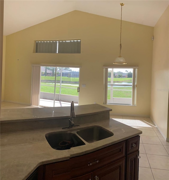 2688 Hawthorne Ln, Kissimmee, FL 34743 - kitchen featuring a sink, high vaulted ceiling, healthy amount of natural light, light tile patterned floors, and pendant lighting