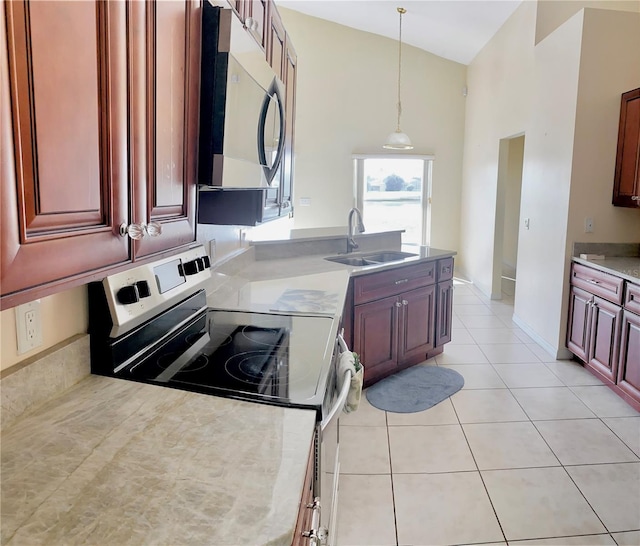 kitchen with decorative light fixtures, range, light tile patterned floors, high vaulted ceiling, and sink