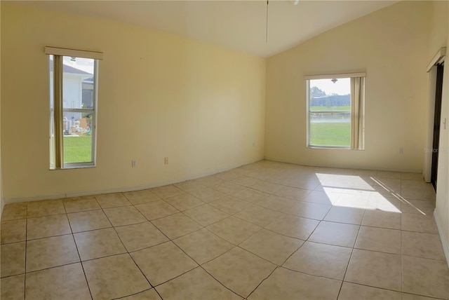 tiled empty room with vaulted ceiling