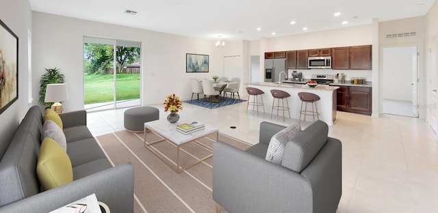 living room with sink and light tile patterned floors