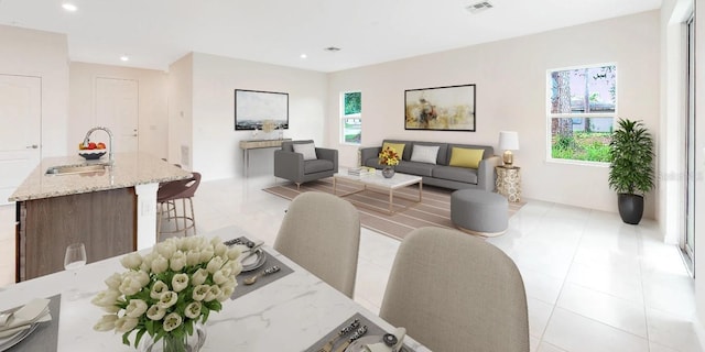 living room featuring sink and light tile patterned floors