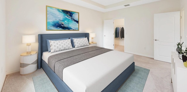 carpeted bedroom featuring a walk in closet and a closet