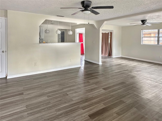 unfurnished living room featuring a textured ceiling, ceiling fan, and dark hardwood / wood-style flooring