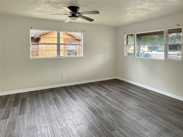 1904 Historic Goldsboro Blvd, Sanford, FL 32771 - spare room featuring a textured ceiling, baseboards, dark wood-style floors, and a ceiling fan