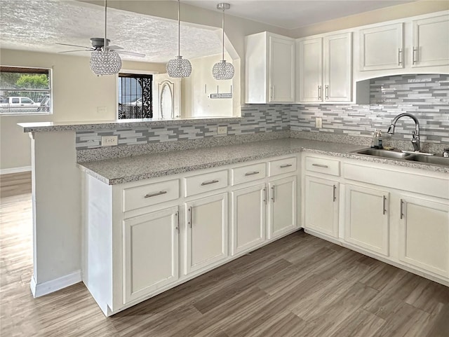 1904 Historic Goldsboro Blvd, Sanford, FL 32771 - kitchen featuring backsplash, light wood-style flooring, ceiling fan, and a sink