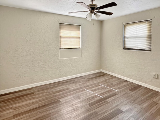 1904 Historic Goldsboro Blvd, Sanford, FL 32771 - unfurnished room featuring wood finished floors, a textured ceiling, baseboards, ceiling fan, and a textured wall