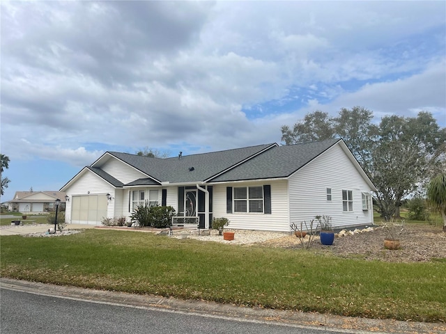 ranch-style home featuring a garage, driveway, a front lawn, and a shingled roof