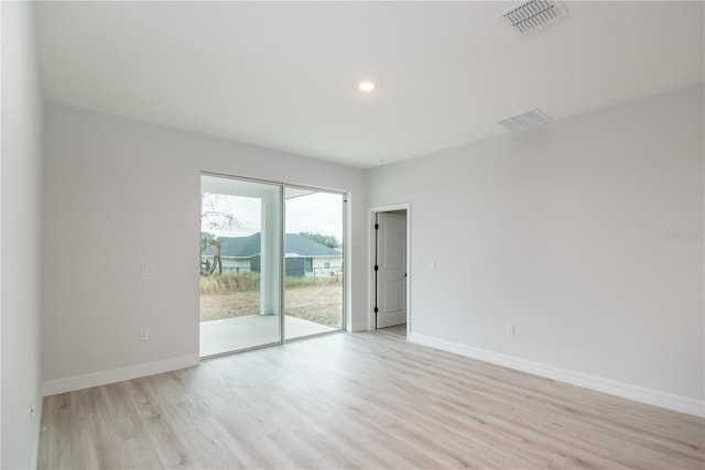 unfurnished room with light wood-type flooring