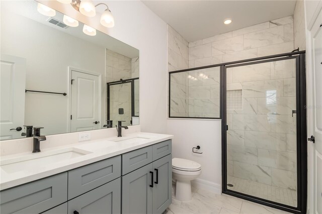 bathroom featuring vanity, toilet, and a shower with door