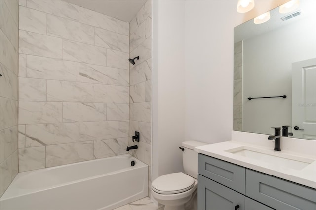 full bathroom featuring tiled shower / bath combo, toilet, and vanity